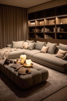 a living room filled with lots of furniture next to a book shelf and bookshelf