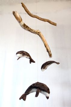 an animal mobile made out of driftwood and branches hanging from it's sides