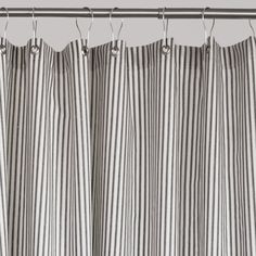 black and white striped curtains hanging on a metal rod