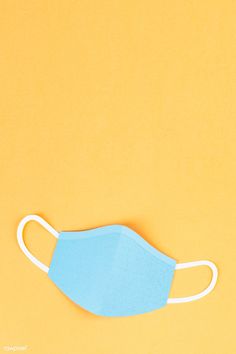 a blue face mask on a yellow background