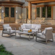 an outdoor living area with white furniture