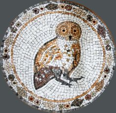 an owl is sitting on top of a mosaic