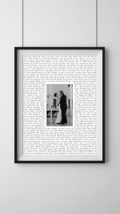 a black and white photo hanging on the wall next to a frame with words all over it