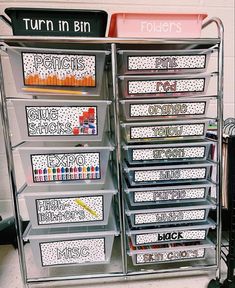 an organized classroom storage unit with lots of bins