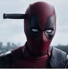 the deadpool character is wearing a red mask and black leather jacket with horns on his head