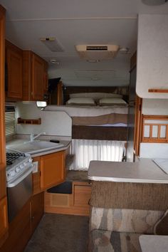 the inside of an rv with wood cabinets