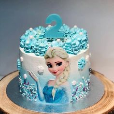 a frozen princess birthday cake with blue frosting