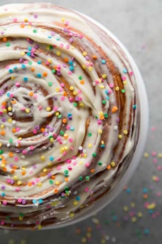 a cup filled with frosting and sprinkles