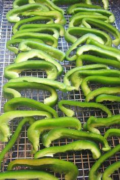 some green peppers are on a wire rack