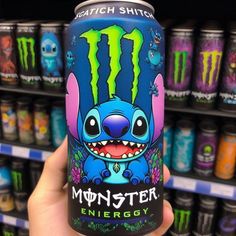 a person holding up a monster energy drink in front of some shelves with monsters on it