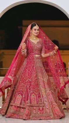 a woman in a red and gold bridal gown