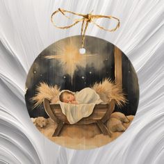 an ornament with a baby in a crib on it's side