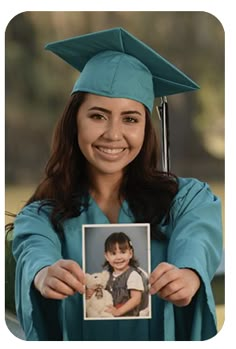 a woman in a graduation cap and gown holding up a photo