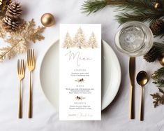 a place setting with pine trees and gold cutlery