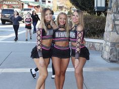 three beautiful women standing next to each other