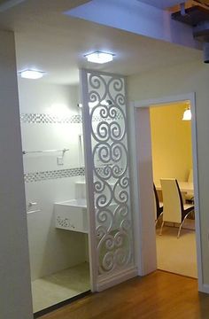 an open door leading to a bathroom and dining room