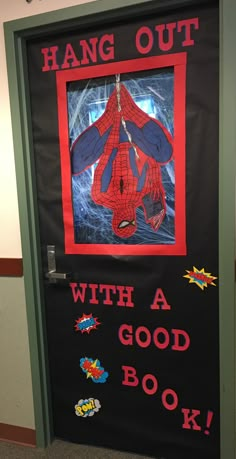 a door decorated with an image of a spider man and the words hang out with a good book