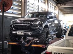 a man working on a truck in a garage