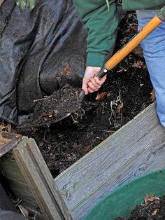 a person is digging in the dirt with a shovel