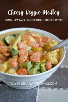 a bowl filled with broccoli, cauliflower and tomatoes