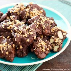 chocolate covered cookies with nuts on a blue plate