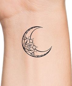 a black and white photo of a crescent tattoo