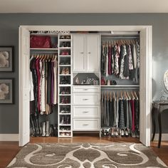 a walk in closet filled with lots of clothes and shoes on top of shelves next to a rug