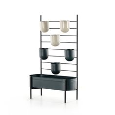 a black shelf with four cups on it and three lights hanging from the ceiling above