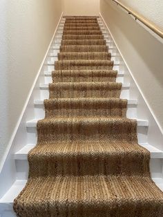 a carpeted staircase leading up to the second floor