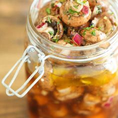 a jar filled with food sitting on top of a wooden table