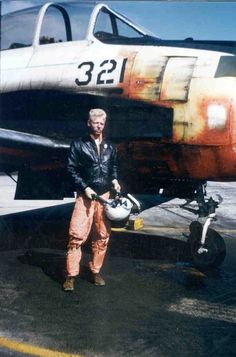 a man standing next to an airplane on the tarmac