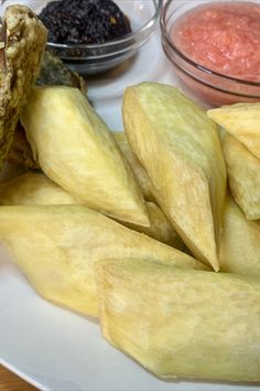 there are many different types of food on the plate, including chips and dips