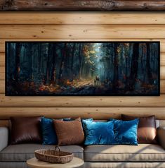 a painting hanging on the wall above a couch in a room with wood paneling