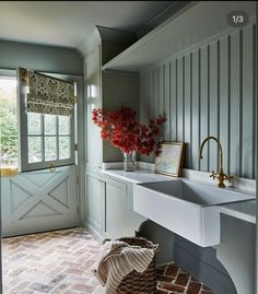 a white sink sitting under a window in a bathroom