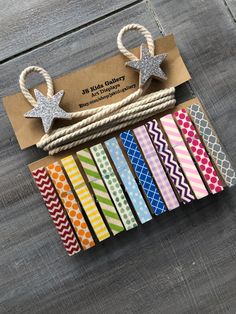 colorful washi tapes are tied together with twine and star shaped tags on them