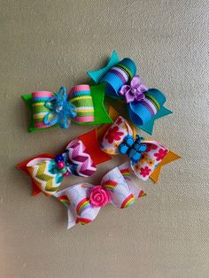 Five cute dog hair bows, two rainbow, one butterfly with flowers, and two striped with flower centers. Striped Hair, Flowers Butterfly