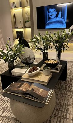 a living room filled with furniture and a flat screen tv mounted above it's entertainment center