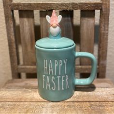 a ceramic cup with a handle that says happy easter on it sitting on a wooden chair