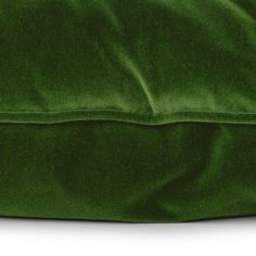 a green velvet pillow on a white background