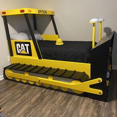 a bed made to look like a bulldozer with a cat logo on it