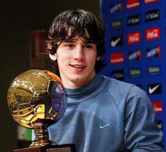 a young man holding an award in his hands