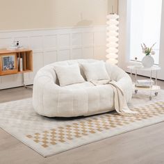 a living room filled with furniture and a white rug