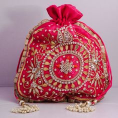 "Beautiful Golden Ribbon Cut Work Thread Embroidered Beaded Indian Traditional Wedding Potli Bags Bridemaids Gift Handbag Material: Organza, Golden Ribbon, Golden Tread, Golden Sequins, Motifs Package Contents: As per quantity purchased Size: 10\" x 8\" Designed with the heart, this beautiful Potli or batawa bag are eye catchy and made of premium material. Key Features: Embroidery art work This potli is good match with both Indian and western outfits and are superb for wedding and festive partie Embellished Pouch Bag For Reception, Embroidered Pouch For Reception, Beaded Festival Clutch Bag, Beaded Clutch Bags For Festivals, Festival Beaded Clutch Bag, Pink Zari Work Bag For Reception, Reception Pouch Bags With Dori Work, Traditional Beaded Clutch Bag, Red Embroidered Shoulder Bag For Wedding