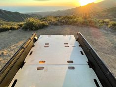 the back end of a truck on a dirt road