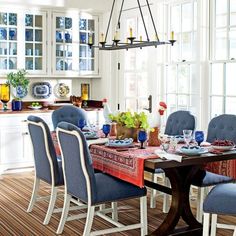 a dining room table with blue chairs around it