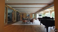 a living room filled with furniture and a piano