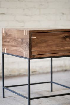 a wooden drawer sitting on top of a metal frame