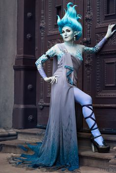 a woman with blue hair is dressed up as a monster