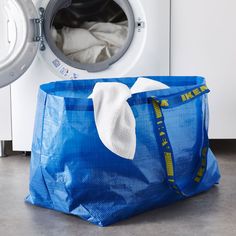 a laundry bag sitting next to a washing machine