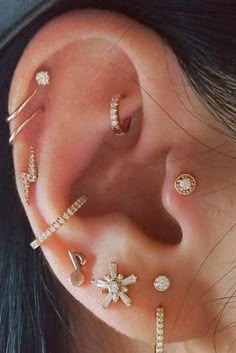 a woman with ear piercings and jewelry on her ears